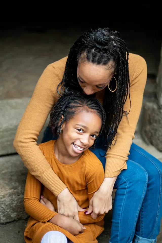 Mother and daughter, both with braided styles